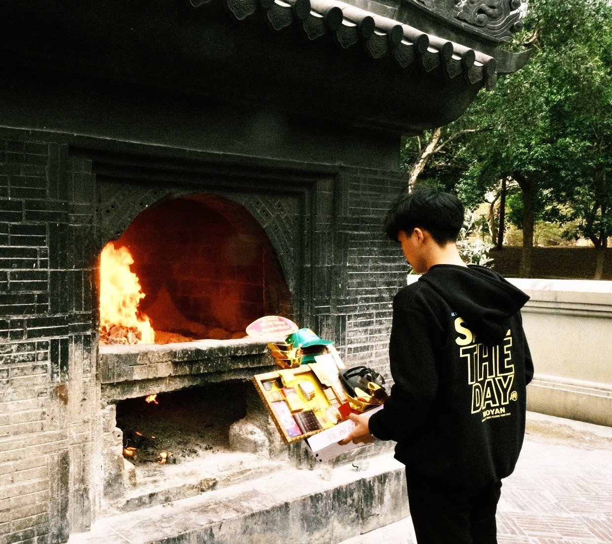 A visitor lighting incense at Hang Duong Cemetery