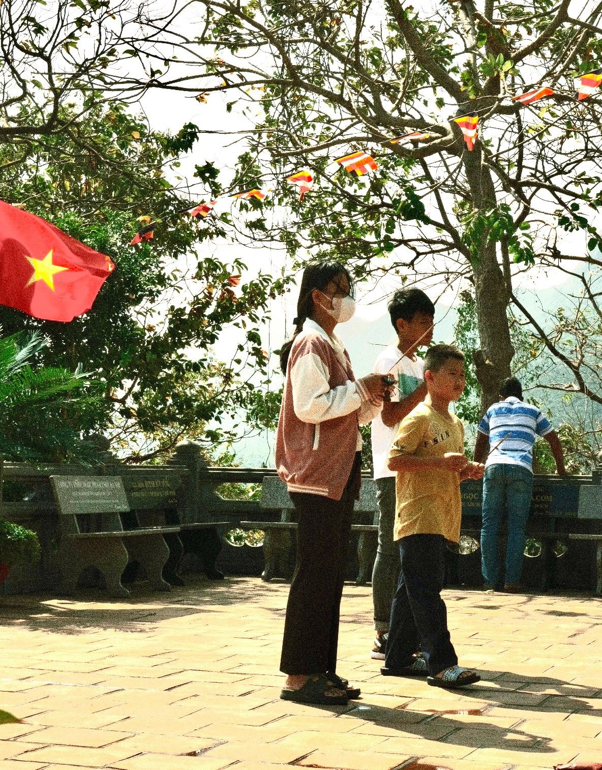 Locals with a Vietnamese flag during Tet at Van Son Tu Pagoda, Con Dao