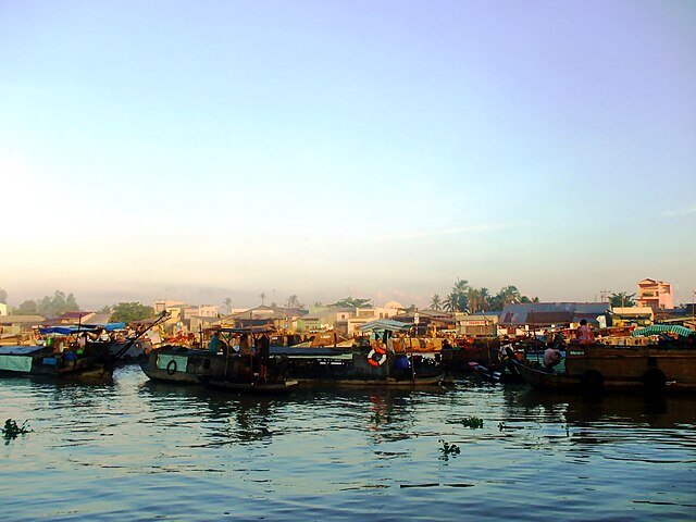 Wooden boats gathered at a Mekong Delta floating market at dawn