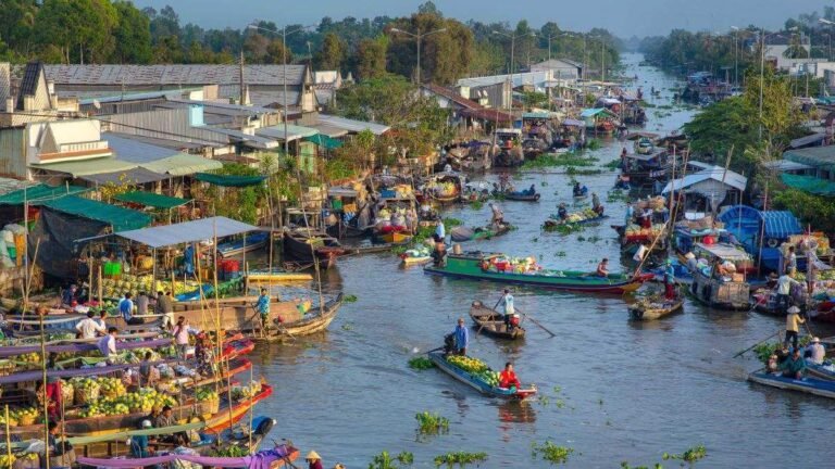 Boats loaded with produce at a floating market on a Mekong Delta canal near Soc Trang