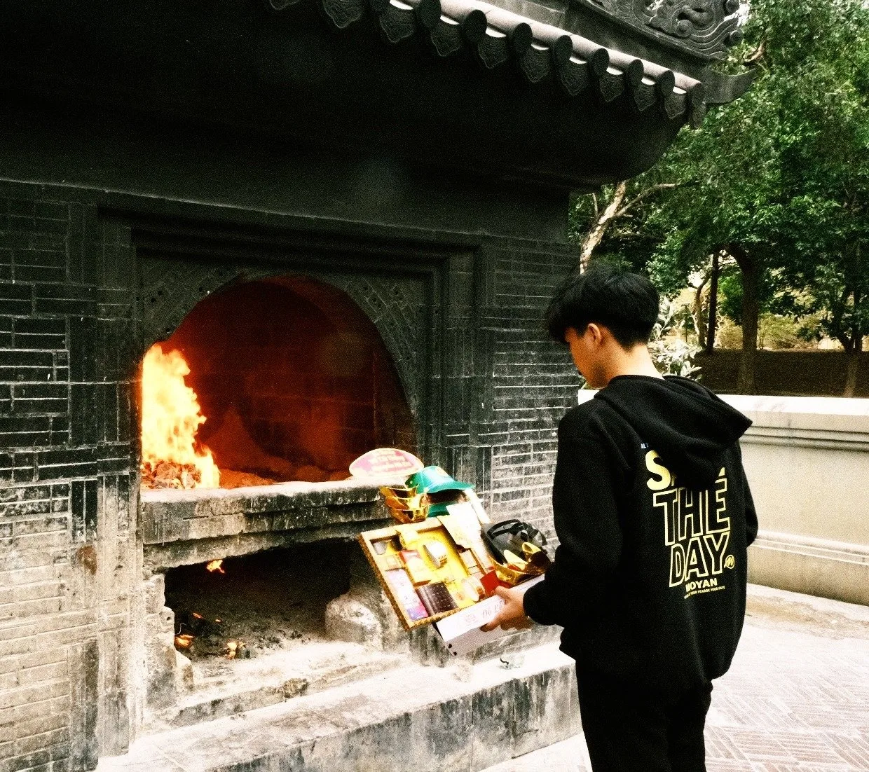 A visitor lighting incense at Hang Duong Cemetery